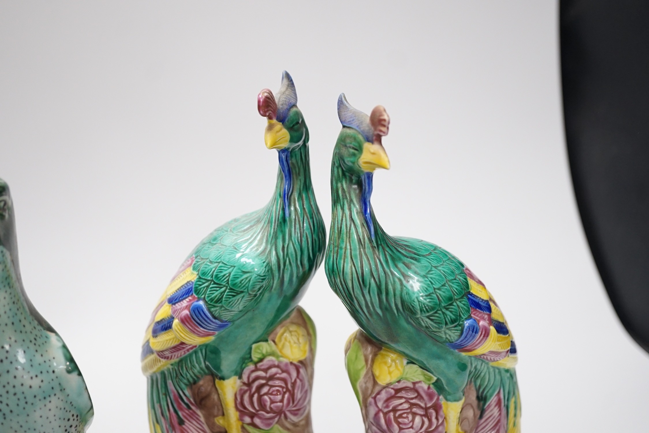 A pair of Chinese polychrome porcelain pheasants and a pair of parrots, tallest 27cm